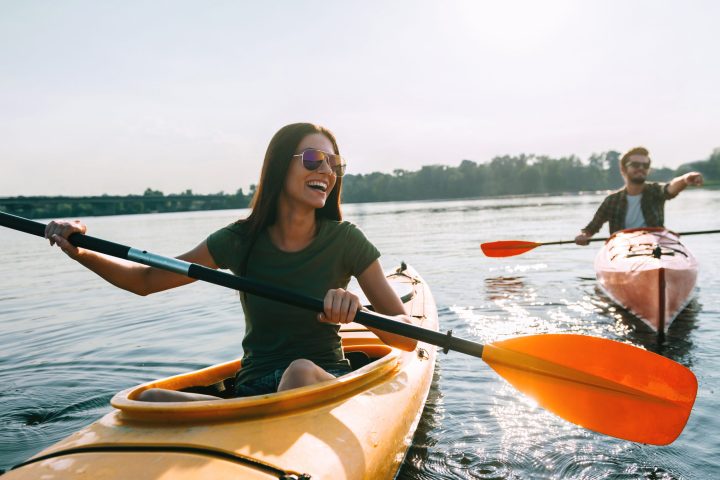 a group of people rowing a boat in the water